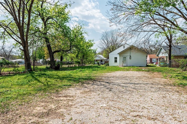 view of yard with fence and driveway