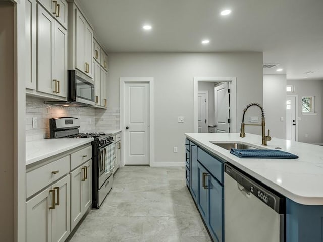 kitchen featuring backsplash, appliances with stainless steel finishes, recessed lighting, and a sink