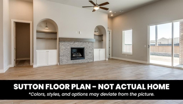 10000 Calypso Way, Yukon, OK 73099 - unfurnished living room with ceiling fan, plenty of natural light, built in features, recessed lighting, and a towering ceiling