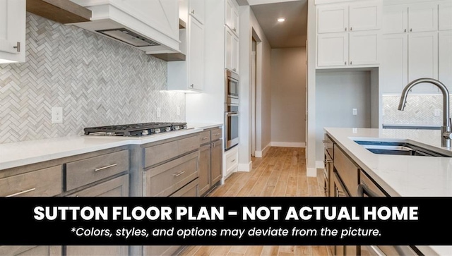 10000 Calypso Way, Yukon, OK 73099 - kitchen featuring stainless steel appliances, tasteful backsplash, white cabinetry, light wood finished floors, and recessed lighting