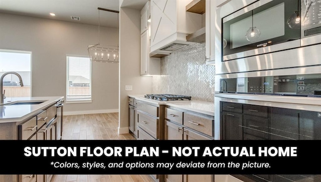 10000 Calypso Way, Yukon, OK 73099 - kitchen featuring stainless steel appliances, backsplash, custom range hood, light wood-style flooring, and light countertops