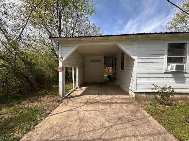 view of car parking with a carport, cooling unit, and driveway