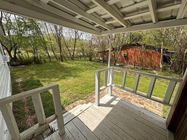 deck featuring an outdoor structure and a yard