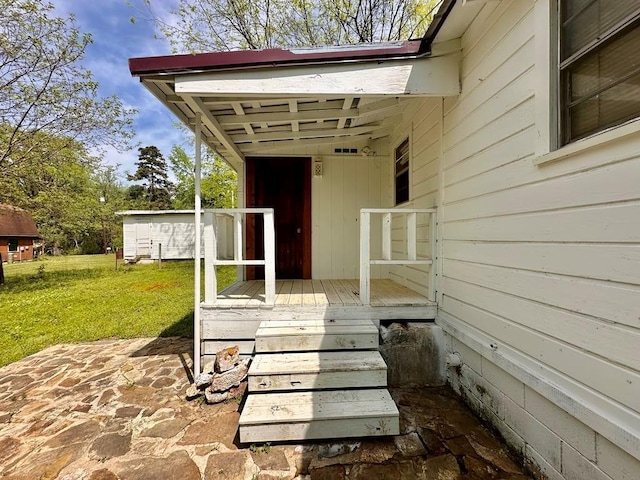 doorway to property featuring a yard and a wooden deck