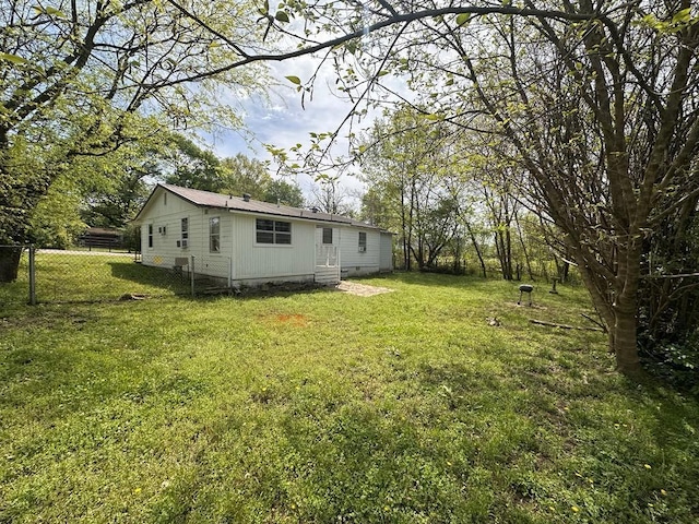 view of yard with fence and entry steps