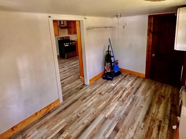 unfurnished room featuring baseboards and wood finished floors