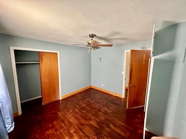 unfurnished bedroom with baseboards, ceiling fan, a closet, and wood finished floors