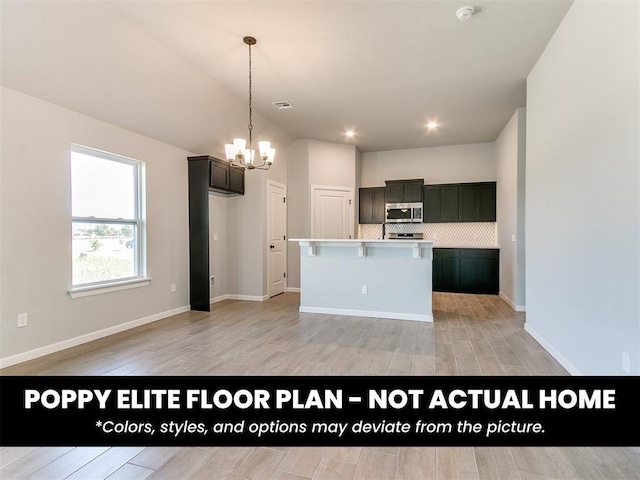 1116 SW 139th St, Oklahoma City, OK 73170 - kitchen with stainless steel microwave, a chandelier, tasteful backsplash, light countertops, and a center island with sink