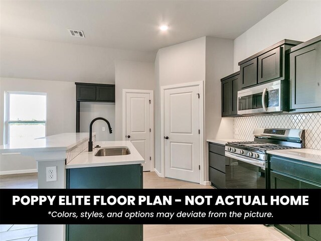 1116 SW 139th St, Oklahoma City, OK 73170 - kitchen featuring stainless steel appliances, a sink, tasteful backsplash, a kitchen island with sink, and light countertops