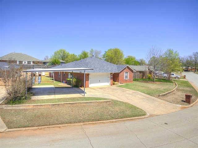 933 Luglena Ln, Purcell, OK 73080 - ranch-style house featuring a garage, brick siding, a front yard, concrete driveway, and a carport