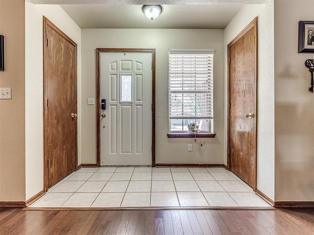 933 Luglena Ln, Purcell, OK 73080 - foyer with light wood-style floors, baseboards, and a textured wall