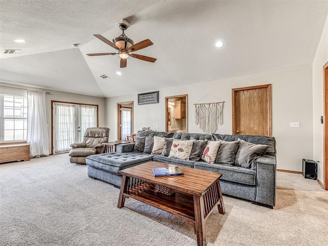 933 Luglena Ln, Purcell, OK 73080 - living room featuring light carpet, lofted ceiling, a ceiling fan, healthy amount of natural light, and a textured ceiling
