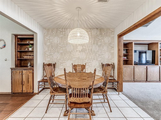 933 Luglena Ln, Purcell, OK 73080 - dining area with a chandelier, wallpapered walls, light tile patterned floors, and baseboards