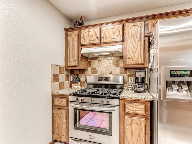933 Luglena Ln, Purcell, OK 73080 - kitchen featuring stainless steel appliances, under cabinet range hood, decorative backsplash, and brown cabinetry