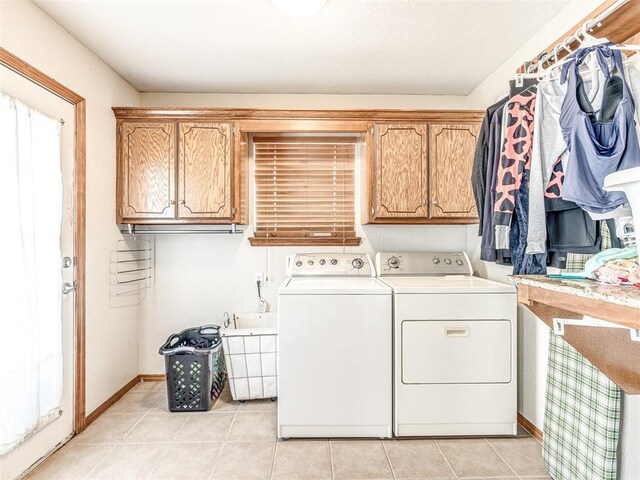933 Luglena Ln, Purcell, OK 73080 - laundry area with washing machine and dryer, cabinet space, baseboards, and light tile patterned floors