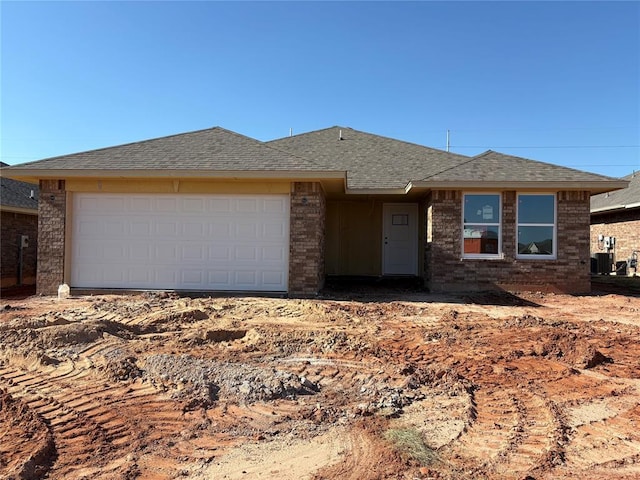 2333 SE 89th Ter, Oklahoma City, OK 73160 - single story home with roof with shingles, a garage, brick siding, and central AC