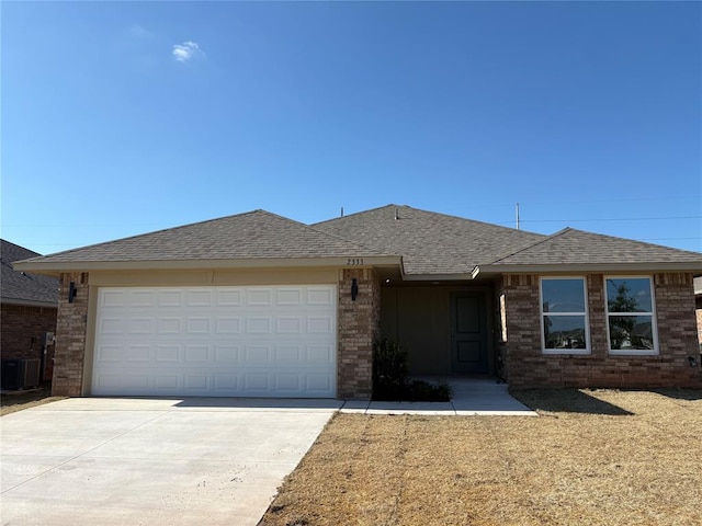 2333 SE 89th Ter, Oklahoma City, OK 73160 - single story home featuring driveway, a garage, brick siding, and a shingled roof