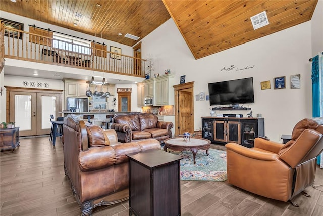living area featuring visible vents, high vaulted ceiling, and wooden ceiling