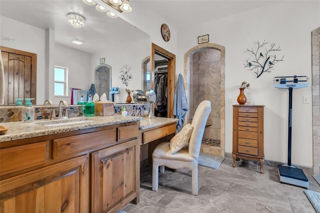bathroom with a walk in shower and vanity