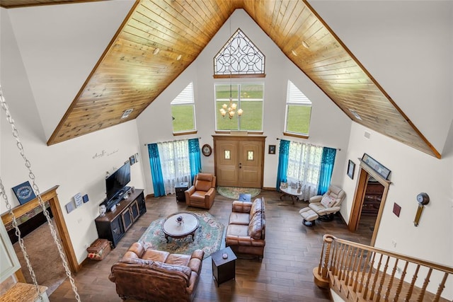 living room with high vaulted ceiling, a wealth of natural light, wood-type flooring, and a chandelier