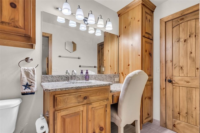 bathroom featuring toilet and vanity