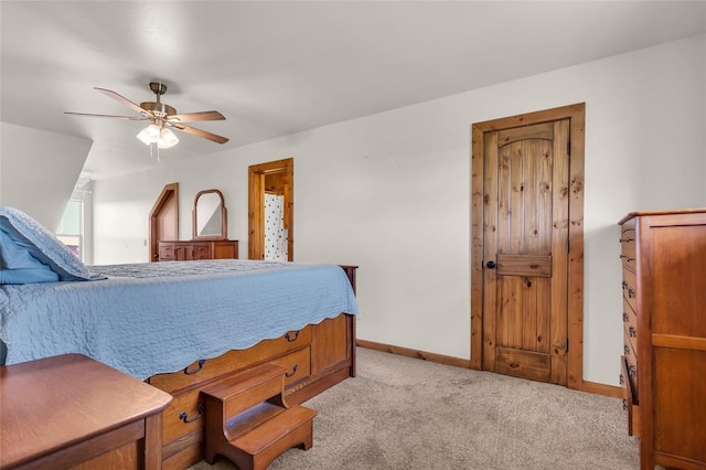 bedroom with light carpet, baseboards, and a ceiling fan