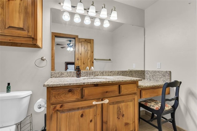 bathroom featuring toilet and vanity