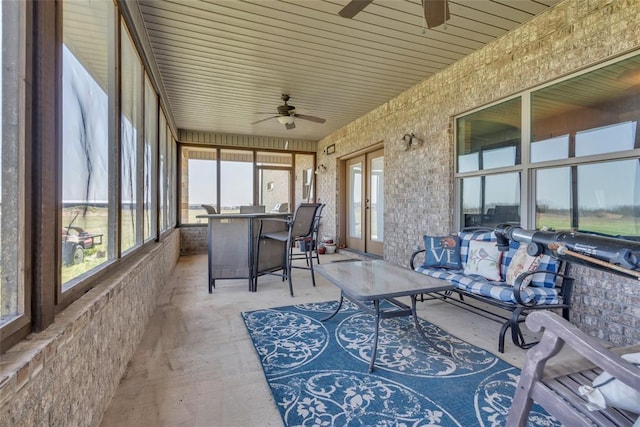 sunroom / solarium featuring french doors and a ceiling fan