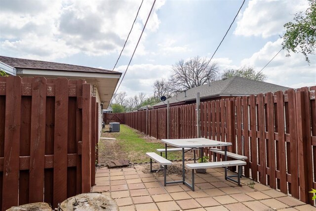 515 W Tennessee Ave, Pauls Valley, OK 73075 - fenced backyard with cooling unit, a patio, and outdoor dining area