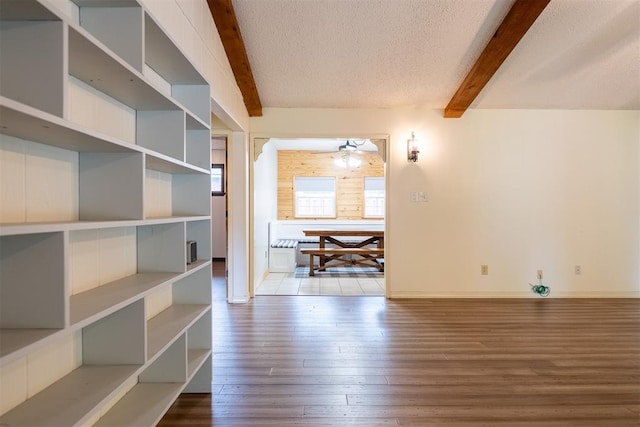515 W Tennessee Ave, Pauls Valley, OK 73075 - hallway with beam ceiling, wood finished floors, baseboards, and a textured ceiling
