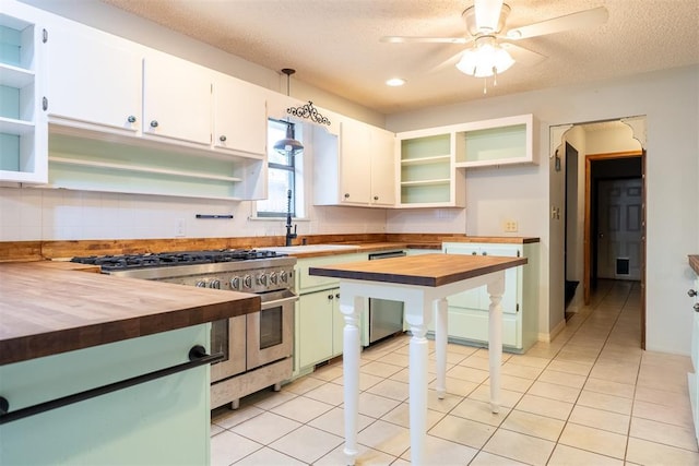 515 W Tennessee Ave, Pauls Valley, OK 73075 - kitchen with open shelves, wood counters, double oven range, a sink, and a ceiling fan