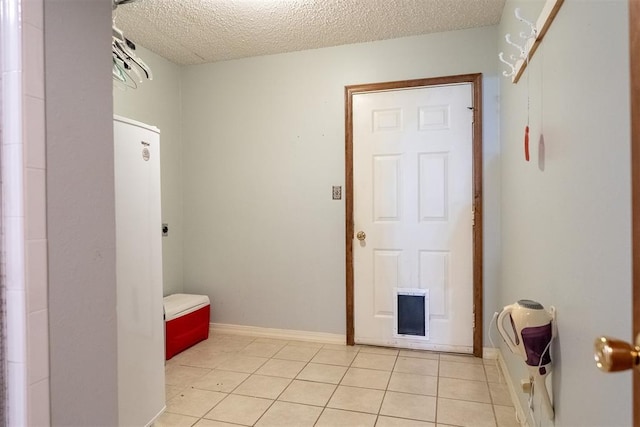 515 W Tennessee Ave, Pauls Valley, OK 73075 - bathroom with a textured ceiling, tile patterned flooring, and baseboards