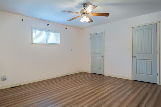 515 W Tennessee Ave, Pauls Valley, OK 73075 - unfurnished bedroom with light wood-type flooring, baseboards, and ceiling fan