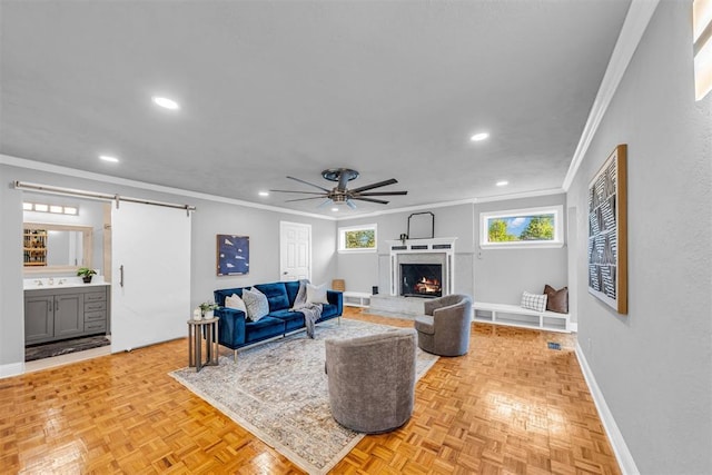 2736 Pembroke Ter, Oklahoma City, OK 73116 - living area with a barn door, recessed lighting, a ceiling fan, ornamental molding, and baseboards