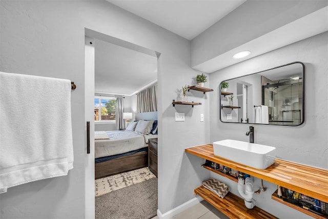 2736 Pembroke Ter, Oklahoma City, OK 73116 - full bathroom with ensuite bath, a shower with shower door, a sink, and baseboards