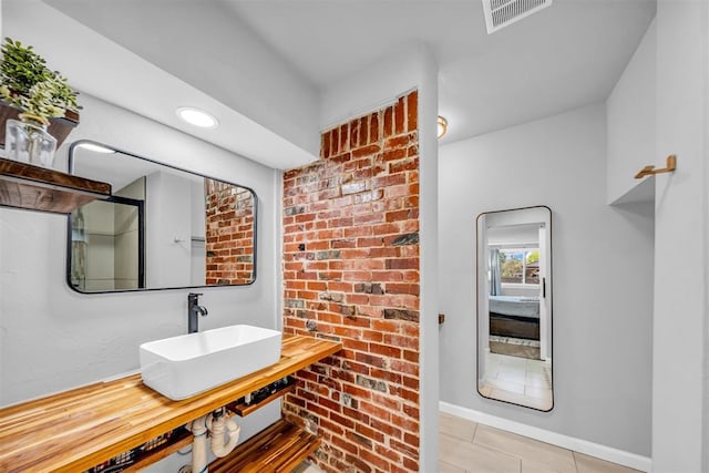 2736 Pembroke Ter, Oklahoma City, OK 73116 - bathroom with visible vents, tile patterned flooring, baseboards, and a sink