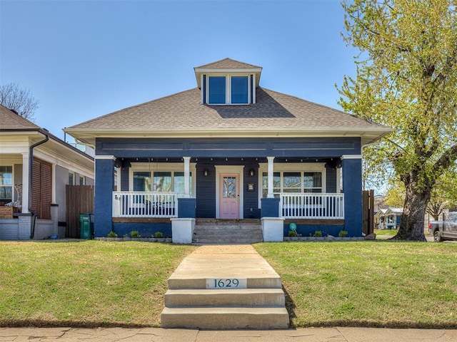 1629 N Klein Ave, Oklahoma City, OK 73106 - view of front facade featuring roof with shingles, covered porch, and a front lawn