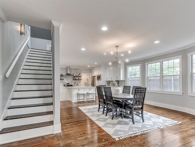 1629 N Klein Ave, Oklahoma City, OK 73106 - dining area with ornamental molding, visible vents, stairway, wood finished floors, and a notable chandelier