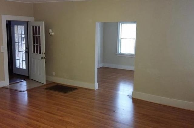 entrance foyer with wood finished floors and baseboards