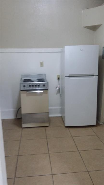 details featuring baseboards and white appliances