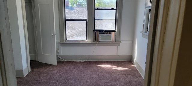 carpeted spare room with cooling unit and a wealth of natural light