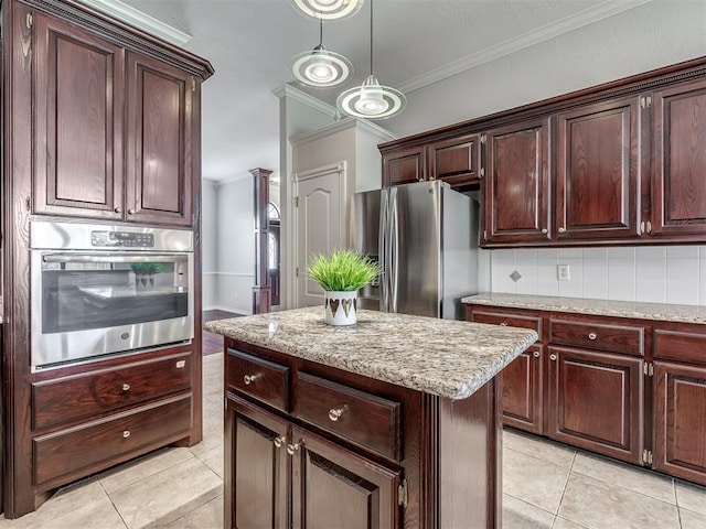 kitchen with light stone counters, a center island, crown molding, light tile patterned floors, and stainless steel appliances