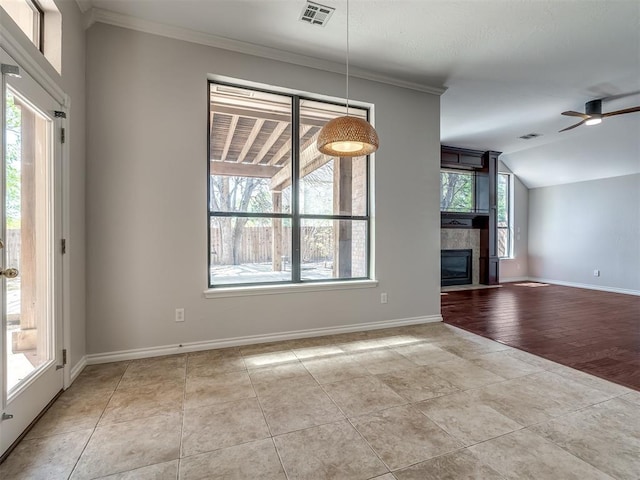 unfurnished living room featuring visible vents, crown molding, baseboards, and ceiling fan