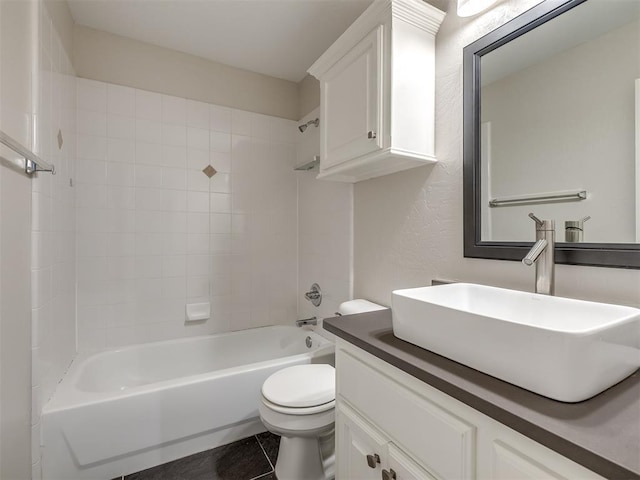 bathroom with shower / bathing tub combination, tile patterned floors, vanity, and toilet