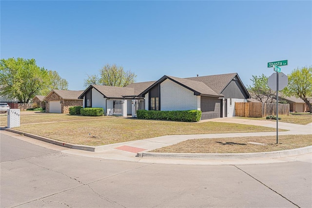 11800 Shasta Ln, Oklahoma City, OK 73162 - ranch-style house with concrete driveway, a front yard, fence, and a garage