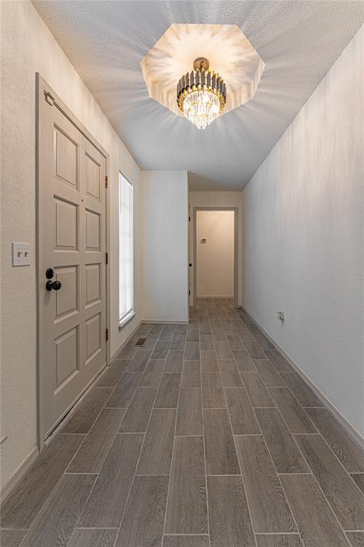 11800 Shasta Ln, Oklahoma City, OK 73162 - entrance foyer featuring an inviting chandelier and wood tiled floor