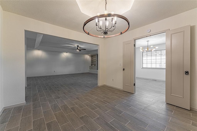 11800 Shasta Ln, Oklahoma City, OK 73162 - spare room featuring a textured ceiling, ceiling fan with notable chandelier, baseboards, and dark wood finished floors