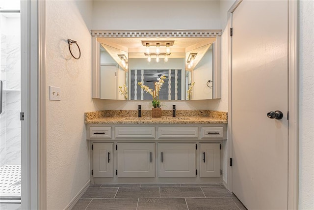 11800 Shasta Ln, Oklahoma City, OK 73162 - full bathroom featuring a sink, a tile shower, double vanity, and a textured wall