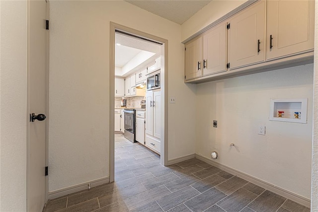 11800 Shasta Ln, Oklahoma City, OK 73162 - laundry area with electric dryer hookup, baseboards, hookup for a gas dryer, washer hookup, and cabinet space