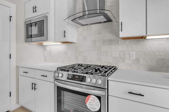 508 NW 175th St, Edmond, OK 73012 - kitchen with stainless steel gas range oven, ventilation hood, light countertops, and black microwave